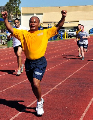 Man running across the finish line