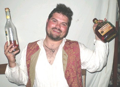 Mad Jack holding up two bottles of rum