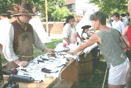 People talking to Mission the surgeon at his display table