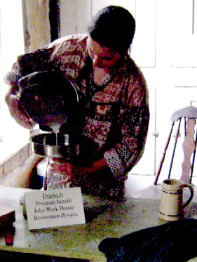 Andrea straining the milk back at the house