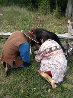 Andrea showing Mission how to milk a goat