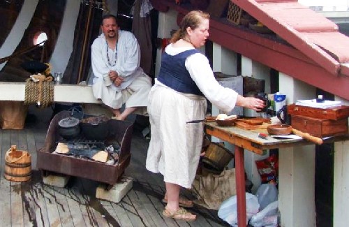 Jennie cooks while brother Dan looks on