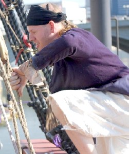 Sam clambors over the edge of the ship