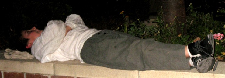 Andrew lying on the R-Bar patio wall