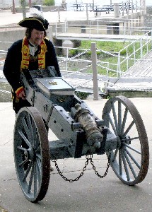 Red John wheels his cannon along the sidewalk