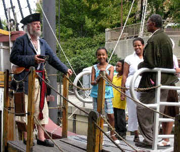 Mark on the gang plank talking with a family
