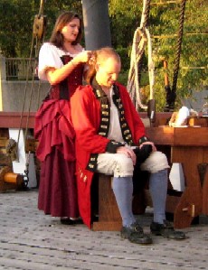 Rachel doing something with Sam's hair