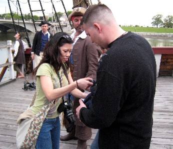 Photographer arranging her camera with her husband