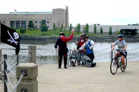 Riske's preparing to fire their cannon as a cyclist passes them by