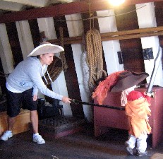 Mother stabbing kid in the back with foam sword