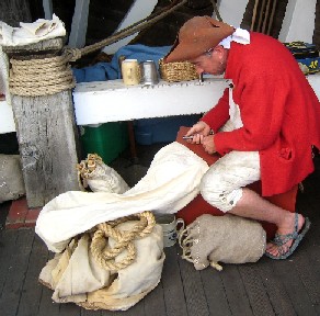 Silas working on his sailor's bag