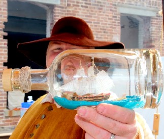 William Holding the Mercury Ship in a Bottle