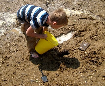 Ryan pouring water from a bucket