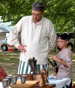 Man and son studying pewter mugs