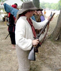 Michael holding gun while checking it