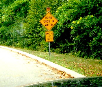 Road ends in water sign