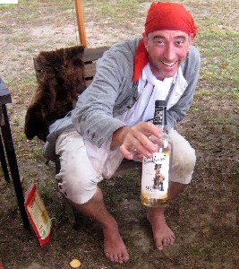 Silas offering a bottle of Sailor Jerry's