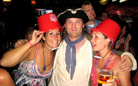 Michael poses with two girls with buckets on their heads
