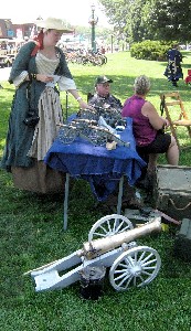 Kate admiring the table of mini-cannons