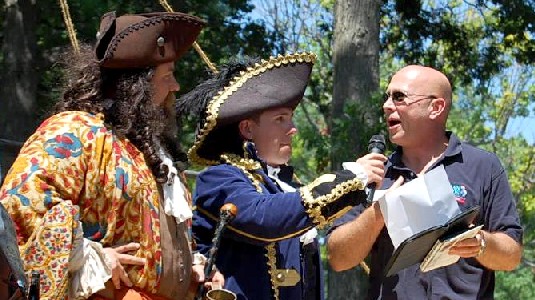 Man presenting the Cayman Islands certificate to M.A. d'Dogge