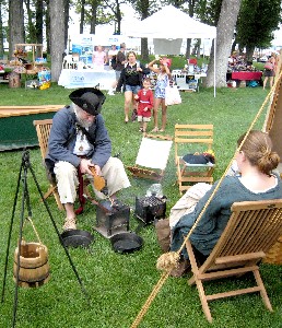 Mark Gist tends the grill while Kate watches