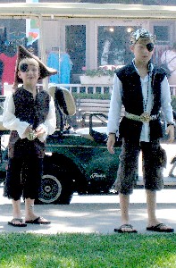 Two other boys in pirate garb and flip flops