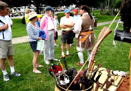 M.A. d'Dogge explains weapons to a crowd