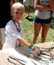 Boy pointing to scissors