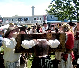 Trish in the stocks looking out