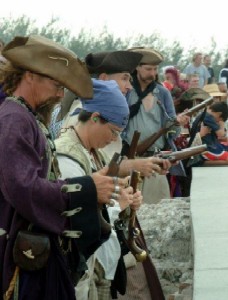 The pirates load their pistols.