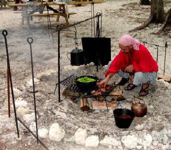 Willie Wobble cooking at the community camp fire