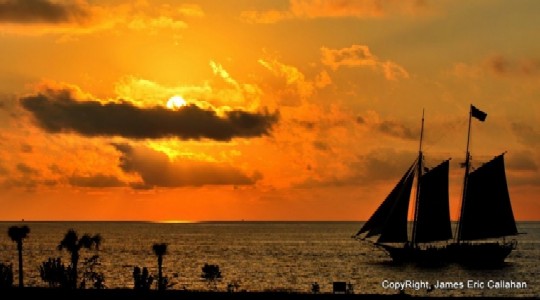 Ship sailing in sunset