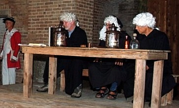 Tjhe bailiff and 3 judges at the table.