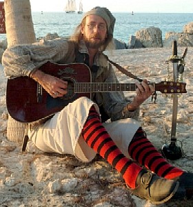 Greg Hudson and his guitar on the beach in Key West