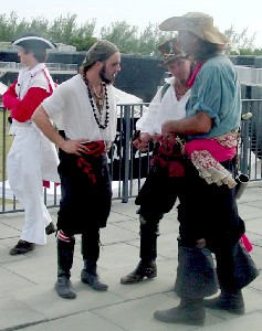 Rogues a-plotting with red coat looking away