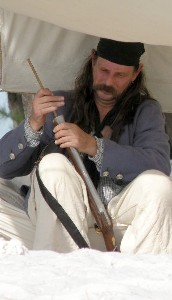 Patrick Hand cleaning his gun