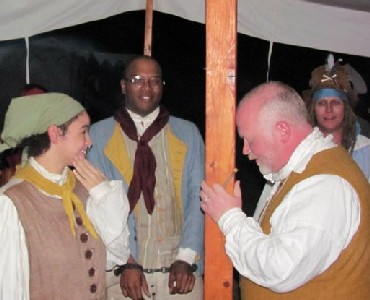 Auctioneer William banging his head on a pole