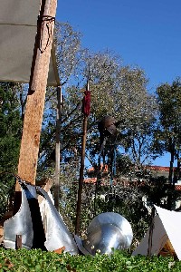 Armor stacked against a tent pole