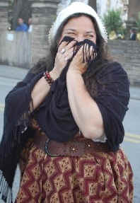 Melissa covers her mouth with her scarf