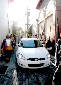 A car amidst the soldiers