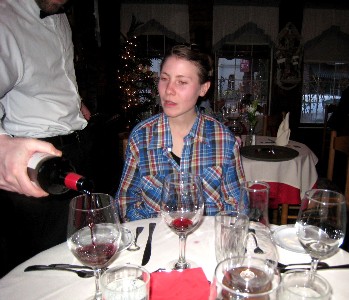 Ru watches the waiter pour wine